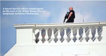  ?? CHIP SOMODEVILL­A, GETTY IMAGES ?? A Secret Service officer stands guard on the roof of the White House after a temporary lockdown Wednesday.