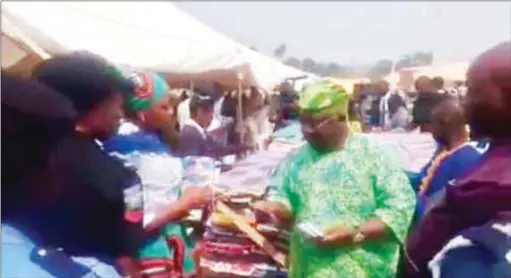  ??  ?? Senator Iyiola Omisore openly buying votes before the Osun State election