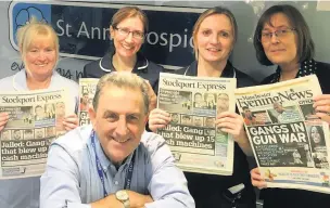  ??  ?? ●●Chief executive Eamonn O’Neal and staff at St Ann’s hospice with copies of the Stockport Express and Manchester Evening News