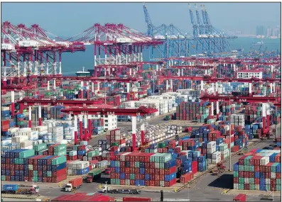  ?? AP ?? Containers sit piled high Thursday at a port in Qingdao, China. China’s export growth accelerate­d in October as companies rushed out shipments before new U.S. tariff rates kick in.