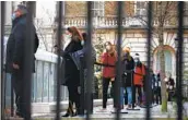  ?? HOLLIE ADAMS GETTY IMAGES ?? People line up for vaccinatio­ns Wednesday in London as COVID-19 cases continue to surge in the U.K.