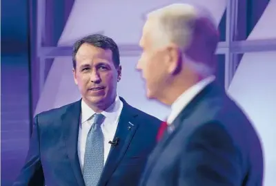  ?? GERRYBROOM­E/AP ?? Democratic challenger Cal Cunningham, left, and Sen. Thom Tillis talk during a debate Oct. 1 in Raleigh, North Carolina.