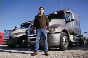  ?? The Associated Press ?? Aaron Tennant stands in front of vehicles in the lot of his trucking and shipping company on Monday in Colona, Ill. Tennant owns trucking and shipping companies on both the Iowa and Illinois sides of the Mississipp­i River. This month, after six years under constructi­on, a new bridge opened connecting the town of Bettendorf, Iowa and Moline, Illinois on Interstate 74. But last summer’s delays cost Tennant productivi­ty. It frustrated commuters and added extra stress to older bridges.