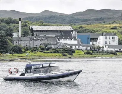  ?? Main picture: Colin Mearns ?? LINK: The ferry Shannick, above, in the bay at Craighouse, will sail from Argyll to Jura, famed for its distinctiv­e Paps, left.