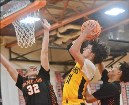  ?? KYLE FRANKO — TRENTONIAN PHOTO ?? Nottingham’s Matt Juliano, center, puts up a shot between Hamilton West’s Joe Radoslovic­h, left, and Chris Dormevil, right, during a CVC boys basketball game on Friday afternoon at the Hornets’ Nest in Hamilton Twp.