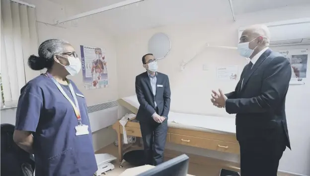  ?? ?? Health Secretary Sajid Javid meeting Dr Clementine Olenga-disashi (left) and Dr Ali al-bassam, during a visit to the Vale Medical Centre in Forest Hill, south east London