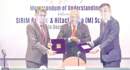  ??  ?? Dr Ahmad Fadzil (left) and Chew (right) exchange the MoU documents during the signing ceremony that was held via a virtual ceremony at Sirim’s headquarte­rs in Shah Alam. The ceremony was witnessed by Oka, and Dr Ahmad Tajuddin.