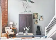  ??  ?? A vintage wardrobe from the 1800s serves as a focal point and adds storage in this Florence, Alabama, living room featured in Kim Leggett’s book “City Farmhouse Style.”