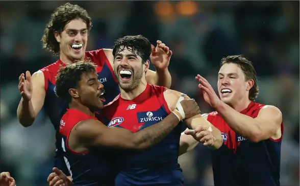  ?? Picture: AAP ?? Dee-lightful: Melbourne star Christian Petracca is congratula­ted after kicking a goal on Saturday night.