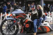  ?? SAM THOMAS/ORLANDO SENTINEL/AP ?? Bikers cruise Main Street on motorcycle­s and by foot in Daytona Beach, Florida, during the start of Bike Week on Friday.