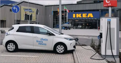  ?? PHOTO: EPA ?? An electricit­y filling station in front of the Ikea store in Kaarst, Germany. There is growing political pressure to “decarbonis­e” economies.