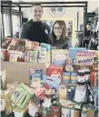  ??  ?? Graham Low and Caroline Arthur with some of the donations.