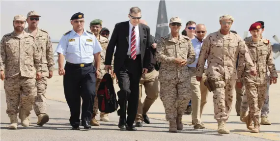  ?? US Ambassador to Yemen Matthew H. Tueller, center, arrives at Mukalla airport, southweste­rn Yemen, on Thursday. ??