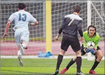  ?? SEAN D. ELLIOT/THE DAY ?? Stonington goalie Peter Fernholz, right, scoops up the ball before New Fairfield’s Braden Reilly (13) can get around Cole DeVoe (7) in a Class M boys’ soccer state tournament game Tuesday.