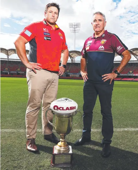  ?? Picture: JASON O'BRIEN ?? Opposing coaches Stuart Dew (Suns) and Chris Fagan (Lions) are keen to get their hands on the QClash trophy.