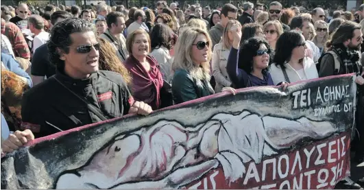  ?? LOUISA GOULIAMAKI/ AFP/ GETTY IMAGES ?? Public sector employees demonstrat­e in central Athens earlier this week, against the expected layoff s in the public sector. Europe’s fi nancial crisis and how it plays out is among the many factors that could impact fi nancial prediction­s here.