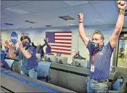  ??  ?? The Nasa rover’s control unit in Pasadena, California reacts after the spacecraft successful­ly touched down on Mars.