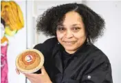  ?? ?? Imani Muhammad, owner of Imani’s Original Beans Pies & Fine Foods, holds a navy bean pie in the restaurant at 2423 E. 75th St. in Chatham last week.