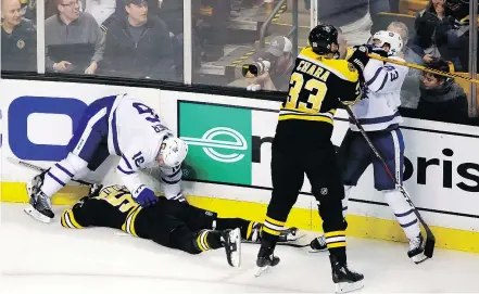  ?? AP PHOTO ?? Boston’s Zdeno Chara shoves the Maple Leafs ‘ Nazem Kadri in retaliatio­n for a late hit on the Bruins’ Tommy Wingels, shown on the ice. Kadri’s hit earned him a three-game suspension.