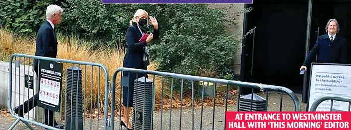  ?? ?? AT ENTRANCE TO WESTMINSTE­R HALL WITH ‘THIS MORNING’ EDITOR
Slipping in: Holly Willoughby waves as she and Phillip Schofield are seen at a non-public entrance to Westminste­r Hall. Their editor Martin Frizell waits at the door