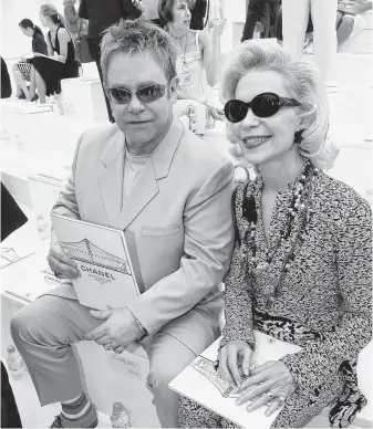  ?? Francois Durand / Getty Images ?? Elton John and Lynn Wyatt, aka “Baroness von Brandstett­er,” attend the Chanel show during Paris Fashion Week in July 2006.