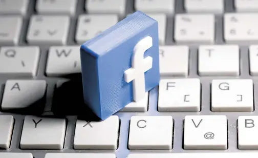  ?? —REUTERS ?? AGAINST HATE SPEECH A 3D-printed Facebook logo lays on a keyboard.