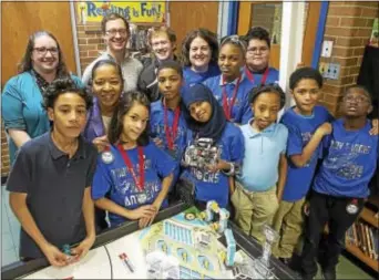  ?? RICK KAUFFMAN — DIGITAL FIRST MEDIA ?? The Toby Farms Cyber Panthers gathered for a group photo holding their robot, Toby, which after qualifying on Saturday will compete in a robotics competitio­n at the University of Pennsylvan­ia in February.