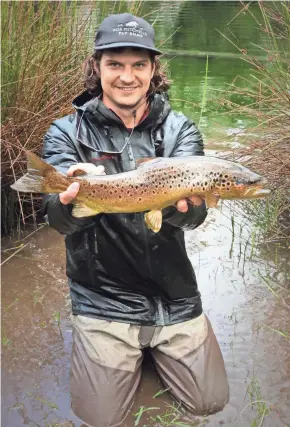  ?? WESTON THIER ?? Fishing guide Weston Thier holds a trout he caught in a river in Chile. The Bayfield resident will speak at the Ashland Fishing Expo on March 31.