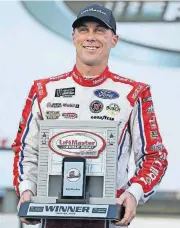  ?? [AP PHOTO] ?? Kevin Harvick poses with the trophy in Victory Lane after winning the pole position during Thursday’s qualifying for Sunday’s NASCAR Cup series race at Charlotte Motor Speedway in Concord, N.C.