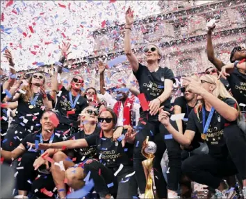  ?? Associated Press ?? Ticker tape — and Champagne — flowed freely Wednesday morning as New York saluted the World Cup winning U. S. women’s soccer team. The parade ended New York’s city hall.