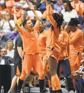  ?? Sean D. Elliot / Associated Press ?? Connecticu­t Sun guard Layshia Clarendon, left, and forward Chiney Ogwumike celebrate on the bench during Sunday’s game against the Sparks.