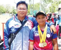  ??  ?? Dzulkarnai­n with his son Muhammad Dzulhelmi who won two gold medals and one bronze medal at the tournament in Perlis in April.