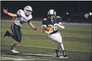  ?? OWEN MCCUE - MEDIANEWS GROUP ?? Spring-Ford’s Harry Adieyefeh (26) runs past Methacton’s Josh Cancro in the Rams’ 21-0 win on Friday, Oct. 16.