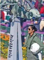  ?? — PTI ?? Flight lieutenant Bhawana Kanth stands on the Indian Air Force tableau as it moves past Rajpath on Tuesday. She became the first woman fighter pilot to take part in the January 26 ceremonial event.