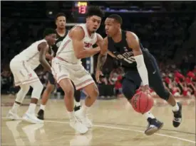  ?? JULIE JACOBSON — THE ASSOCIATED PRESS ?? Penn State guard Tony Carr (10) drives against Utah forward Donnie Tillman (3) in the NIT championsh­ip Thursday in New York. Penn State won 82-66.