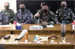  ?? FIRDIA LISNAWATI AP ?? Indonesian Military chief Hadi Tjahjanto, center, display debris found in the waters during a search operation for the Indonesian Navy submarine in Bali, Indonesia on Saturday.