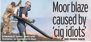  ??  ?? STRUGGLE Soldier works with firefighte­r on Saddlewort­h Moor