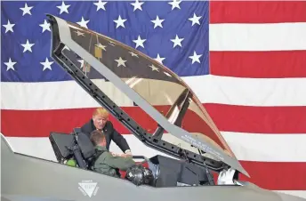  ??  ?? President Donald Trump checks out an F-35 fighter, with Lt. Col Jason Curtis in the cockpit, during a defense capability and roundtable tour Friday at Luke Air Force Base in Glendale.