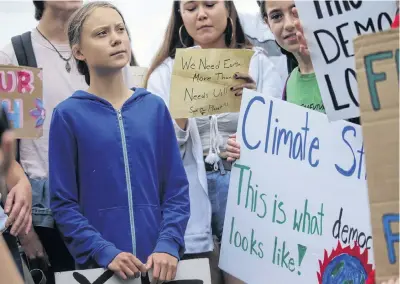  ?? LEAH MILLIS REUTERS ?? Swedish teen climate activist Greta Thunberg and other environmen­tal advocates join Washington, D.c.-area students at a rally on the Ellipse near the White House in Washington on Friday. •