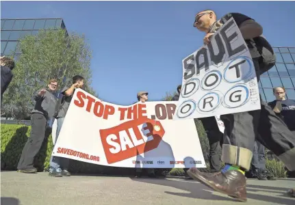  ?? MARK J. TERRILL/AP ?? Cory Doctorow, foreground, and others concerned about the proposed sale of the .org registry protest in Los Angeles outside the headquarte­rs of the Internet Corporatio­n for Assigned Names and Numbers. A private equity firm announced commitment­s designed to ease concerns over its proposed $1.1 billion takeover of the registry.