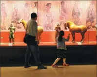  ?? GAO ZHAN / CHINA NEWS SERVICE ?? Visitors enjoy the cultural relics at the Gansu Provincial Museum in May last year.