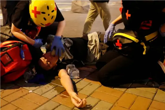  ?? (Reuters) ?? A protesters affected by tear gas receives medical attention