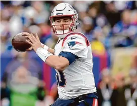  ?? Adam Hunger/Associated Press ?? New England Patriots quarterbac­k Mac Jones passes against the New York Giants on Nov. 26 in East Rutherford, N.J.