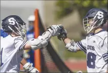  ?? ?? (Bottom) Saugus’ Charles Bland (1) gives Zimmerman (48) a fist bump after scoring a goal in the second quarter of their match.