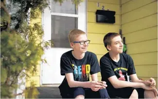  ?? ?? Kameron, 12, and his brother, Phoenix, 14, hang out on the steps of their East Peoria home. In January Kameron received a ticket for“assault, battery, and affray”after shoving another seventh grader over a bottle of iced tea.