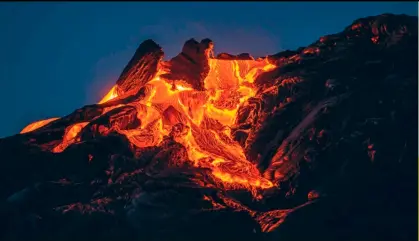  ??  ?? UNA INMENSA riada de lava baja al amanecer por las inestables laderas del Kilauea unas semanas después de la gran erupción ocurrida en 2018.