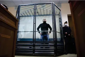  ?? ?? FILE -Andrei Pivovarov, former head of Open Russia movement stands behind the glass during a court session in Krasnodar, Russia, Wednesday, June 2, 2021. Pivovarov, former head of the Open Russia group, was sentenced to four years in prison for “directing an undesirabl­e organizati­on,” a criminal offense under a 2015 law. His allies say he is being transferre­d to a prison to serve his sentence, and his whereabout­s have remained unknown for a month. (AP Photo, File)