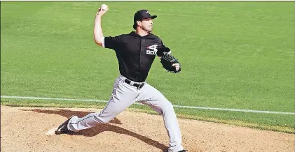 ?? PHOTO BY STEVE MACNAULL ?? The Chicago White Sox’s Scott Carroll warms up before being called in as the relief pitcher in a spring training game against the Los Angeles Angels in Tempe, Arizona.