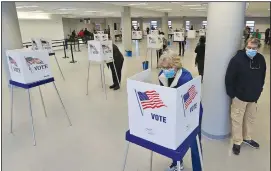  ?? (AP/Tony Dejak) ?? Susan Mariani casts her Ohio primary vote Tuesday in Cleveland. The election, which had been delayed because of the coronaviru­s pandemic, was conducted almost entirely by mail, with in-person voting available for those who requested a ballot but didn’t receive it in time.