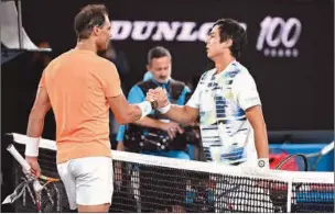  ?? (AFP) ?? Spain’s Rafael Nadal (L) shakes hands with Mackenzie McDonald of the US after losing the men’s singles second round match on day three of the Australian Open in Melbourne on Wednesday.